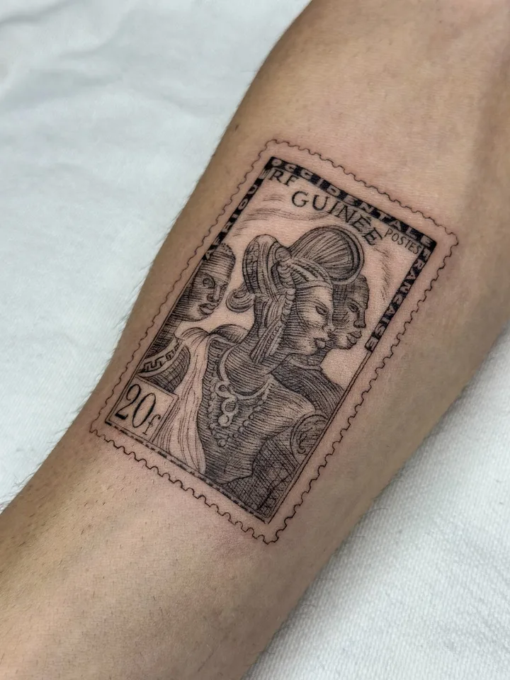 Fine-line tattoo by nurse.tattoo: a Guinée postage stamp, on a forearm