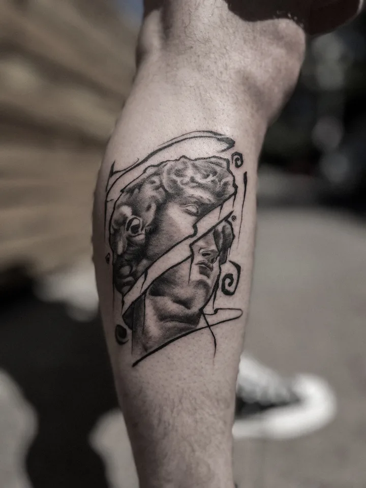 The head of Michelangelo's David split by a diagonal band, black and grey on the calf